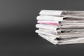 Stack of many newspapers on grey background, space for text Royalty Free Stock Photo