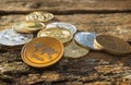Stack of many shiny crypto coins on daylight in nature on wooden table background. Close up of Silver and golden coins of crypt