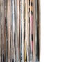 Stack of many vinyl records in old color covers on left side on photo on white background Royalty Free Stock Photo