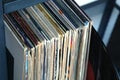 Stack of many vinyl records in old color covers on a shelf side view Royalty Free Stock Photo