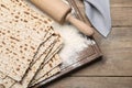 Stack of matzos and rolling pin on wooden table, flat lay Royalty Free Stock Photo
