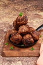 Stack of meatballs on wood cutting board