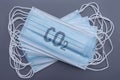 A stack of medical blue masks with a carbon dioxide formula on a gray background Royalty Free Stock Photo