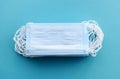 stack of medical masks on a clear blue background. Royalty Free Stock Photo