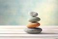 stack of meditation stones on a light wooden table