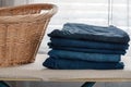 Stack of men`s jeans folded on the ironing board