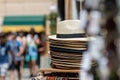 Stack of men and women summer hats on the street market, selective focus, closeup Royalty Free Stock Photo