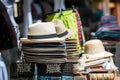 Stack of men and women summer hats on the street market, selective focus, closeup Royalty Free Stock Photo