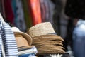 Stack of men and women summer hats on the street market, selective focus, closeup Royalty Free Stock Photo