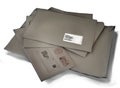 Stack of messy closed brown paper mail envelopes