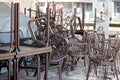 Stack of metal brown chairs and tables in closed coffee shop