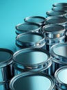 Stack of metallic paint cans on a blue background. Royalty Free Stock Photo