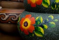 Stack of Mexican ceramic pots, grey background, orange flowers