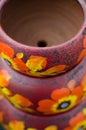 Stack of Mexican ceramic pots, purple background, orange flowers