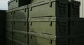 Stack of military-style, olive green storage boxes with metal latches and handles. The Royalty Free Stock Photo