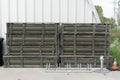 stack of military wooden crates for ammunition or missiles with protective green inserts standing outdoors near a Royalty Free Stock Photo
