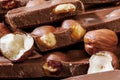 Stack of milk chocolate pieces and hazelnuts