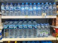 Stack mineral water bottles in a minimarket window Royalty Free Stock Photo