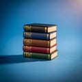 A stack of miniature leather bound books is arranged against a blue Royalty Free Stock Photo