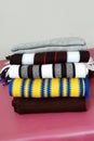 Stack of modern different colors winter woolen scarfs Royalty Free Stock Photo