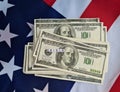 Stack of money on american flag and text financial crisis dollar inflation recession global economy