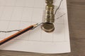 Stack of money coins with graph paper and pencil Royalty Free Stock Photo