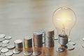 stack money coins growing light bulb concept Royalty Free Stock Photo