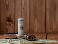 Stack of Money, drugsand a gun on a wooden table, concept about danger and threat of the drug Royalty Free Stock Photo