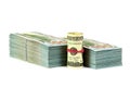 A stack of money with a roll front of it  in white background. Royalty Free Stock Photo