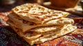 A stack of Moroccan msemen flatbreads on a traditional patterned cloth, a homemade North African breakfast Royalty Free Stock Photo