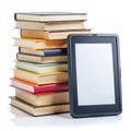 Stack of colorful books next to a black e reader on white background e book tablet Royalty Free Stock Photo