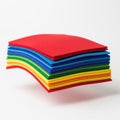 Stack of multicolored felt sheets, floating in mid air on a solid white background Royalty Free Stock Photo