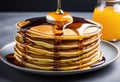 A stack of multicolored pancakes with syrup.