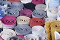 Stack of multicolored quality rugs at carpet shop, Carpets variety selection rolled up rugs shop store Royalty Free Stock Photo