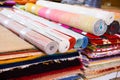 Stack of multicolored quality rugs at carpet shop