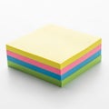 A stack of multicolored sticky notes is neatly arranged on a white surface. The notes Royalty Free Stock Photo