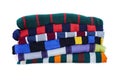 Stack of multicolored striped winter clothes isolated on white background Royalty Free Stock Photo