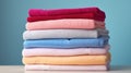 Stack of multicolored towels on white table against a pastel blue background Royalty Free Stock Photo