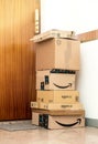 Stack of multiple Amazon prime order arranged near door