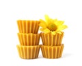 Stack of natural beeswax cake blocks and flower on white background