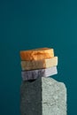 Stack of natural homemade soap bars on a granite cube, blue background, Royalty Free Stock Photo