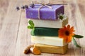 Stack of natural soaps with medicinal plants, flowers and turmeric