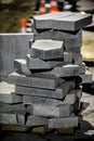 Stack of natural stone paving slabs on city street with night lighting