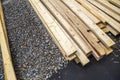 Stack of natural wooden boards on building site. Industrial timber for carpentry, building or repairing, lumber material for