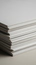 A stack of neatly aligned white paper sheets on a flat surface. The paper has a slight Royalty Free Stock Photo