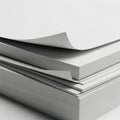 A stack of neatly arranged white and gray paper sheets in a minimalist setting Royalty Free Stock Photo