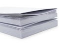 Stack of neatly arranged white and gray paper sheets on a table. isolated on white background Royalty Free Stock Photo