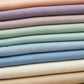 Stack of neatly folded fabrics in pastel shades, including peach, lavende Royalty Free Stock Photo