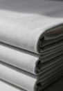 Stack of neatly folded white fabric sheets, arranged vertically. The material appears Royalty Free Stock Photo