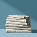 A stack of neatly folded white linens is placed on a flat surface with a smooth blue Royalty Free Stock Photo